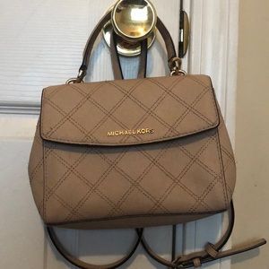 It’s a Michael Kors Hand/around arm bag